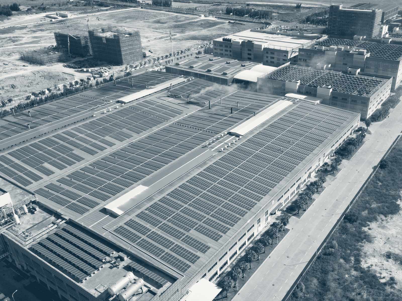 Aerial view of rooftop solar arrays across an industrial facility